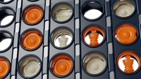 Closeup view of white and orange tokens in a dark blue game  - showing the beautifully crafted game tokens contrasting strongly together.