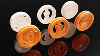 Closeup view of tactile differentiated Orange 3D Orb, King and Delta tokens in the foreground and the same set of white tokens in the background.